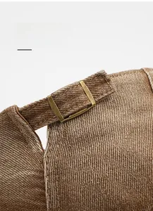 Detail of adjustable bronze metal buckle on washed cotton cap with fabric texture