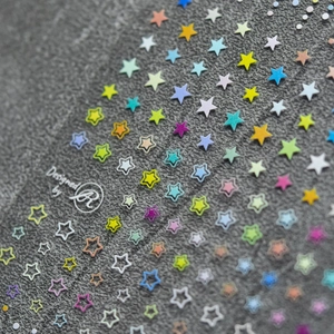 Macro shot of colorful star nail stickers with solid and hollow 3D embossed designs