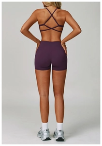 Rear view of purple yoga set with cross-strap back design and high-waist shorts