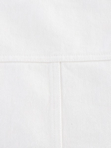 Detailed macro view of white twill denim fabric with high-density straight stitching