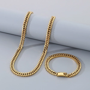 Detail view of gold hip hop Cuban link chain necklace and bracelet jewelry set