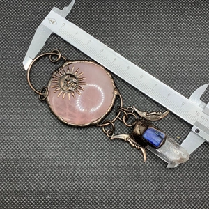 Detailed measurement of vintage sun and moon quartz pendant necklace with a caliper