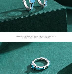 Macro detail of S925 sterling silver hoop earrings with inlaid turquoise stones
