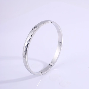 Sleek silver titanium steel bangle with geometric rhombic texture and polished finish