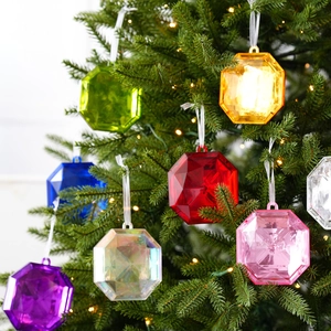 Octagonal crystal-cut Christmas tree ornaments in vibrant colors hanging on branches