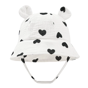 Detail of white cotton baby bucket hat with black heart prints and cute round ears