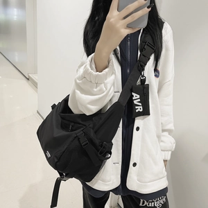 Versatile black techwear crossbody bag with adjustable wide strap and small coin pouch
