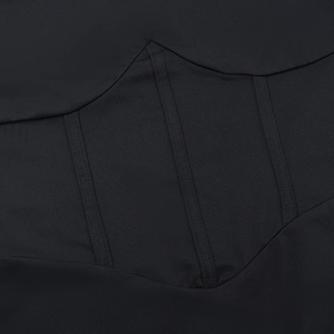 Detailed view of the corset-style stitching and textured fabric on this black jumpsuit