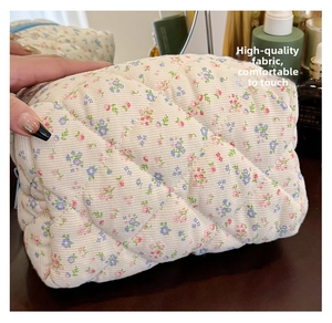 Close-up of quilted floral cotton fabric and soft corduroy texture of the makeup bag