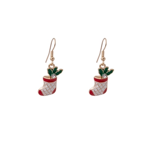 Detailed macro shot of festive Christmas stocking earrings with red enamel and gold trim
