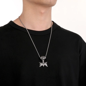Close-up of Viking Mjolnir pendant with double wolf heads on braided metal chain
