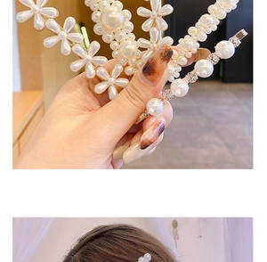 Close-up of pearl hair clips showing floral designs and golden metal base detail