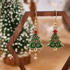 Detail of Christmas tree earrings with green enamel and red star on gold hooks