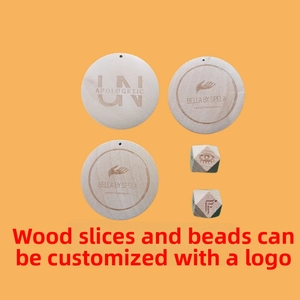 Detail of laser-engraved wooden charms and geometric beads on an orange background