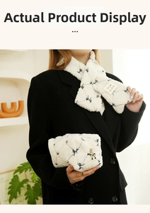 Detailed view of white faux shearling scarf set and makeup bag with bow charm detail