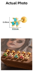 Macro detail of gold plated helix piercing with colorful zircon stones and ball screw back