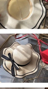 Detail of beige straw hat featuring black wavy edge and ribbon with windproof rope