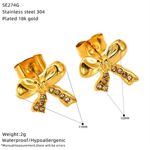 Detail of 18k gold plated bow earrings with size measurements and material specs