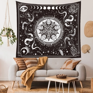 Detailed close-up of a mystical black and white tapestry with moon phases and celestial art