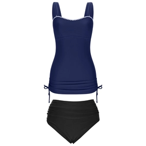 Detail of navy tankini top with white scalloped trim and adjustable side drawstrings