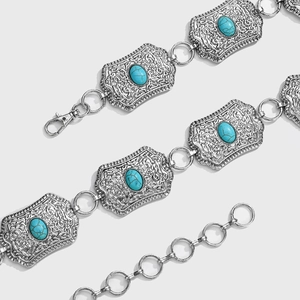 Detail of bohemian silver waist chain featuring turquoise stones and intricate carvings