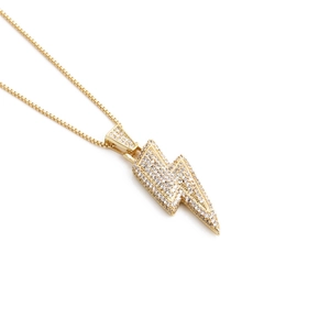 Elegant gold lightning bolt pendant necklace with shimmering crystal pavé on a box chain