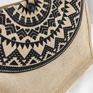 Vintage linen tote bag featuring black geometric ethnic patterns and button closure