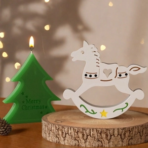 Close-up of a white wooden rocking horse with heart cutout and Christmas tree candle