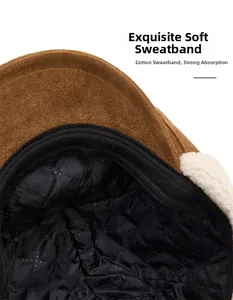 Close-up of brown suede exterior and warm black quilted lining on a beret cap