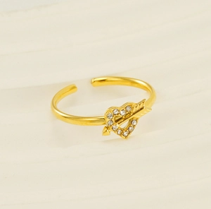 Close-up of golden Cupid's arrow adjustable ring with pavé heart crystals