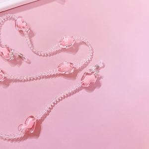 Pink heart-shaped acrylic bead chain for glasses or sunglasses on pink background
