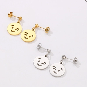 Close-up of smiley face stud earrings in gold and silver finishes on white background