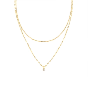 Detail of double-layer gold chain necklace featuring flat links and a sparkling zircon pendant