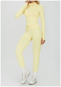 Détail du tissu côtelé sans couture jaune clair sur l'ensemble de yoga avec haut zippé