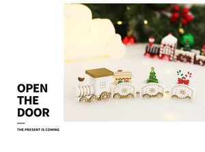 Close-up of white wooden Christmas train with miniature trees on artificial snow surface