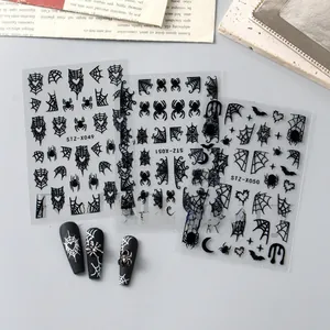 Detail of Halloween nail stickers with black spider webs, bats and heart patterns