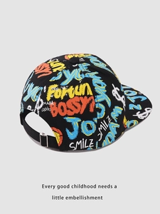 Detail of kids baseball cap featuring colorful graffiti print and adjustable back strap