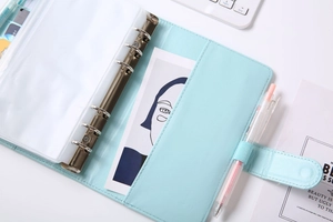 Detailed interior of A6 light blue PU leather binder with 6-ring metal clip and card slots