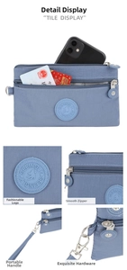 Detail view of the multi-layer zipper compartments and blue nylon fabric of the phone bag