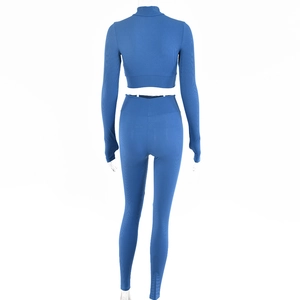 Rear view of women's blue ribbed knit two-piece set with high waist leggings and crop top