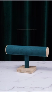 Detail of teal velvet T-bar jewelry stand with natural bamboo base for bracelets