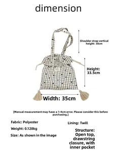 Detail view of plaid tote bag with heart patterns, drawstrings and beige tassels