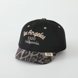 Detail of Los Angeles embroidery and leopard print brim on black baseball cap