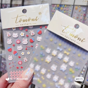 Detailed close-up of 5D embossed nail stickers featuring cute rabbits and hearts