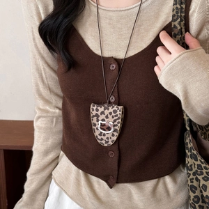 Detail view of leopard print magnetic leather cat glasses clip necklace on a knit vest