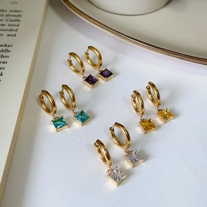 Close-up of square zircon earrings in gold-plated steel with four colorful gemstone charms
