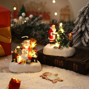 Luminous resin Christmas scenes featuring Santa and a snowman with warm LED lighting