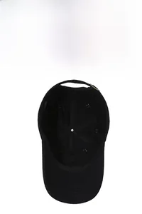 Detail of black cotton baseball cap interior showing sewing tape and metal buckle