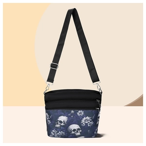 Detail of gothic skull floral print crossbody bag with multiple zipper pockets
