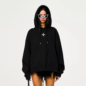 Detailansicht des weißen Kreuzdrucks und der Kängurutasche am schwarzen Hoodie